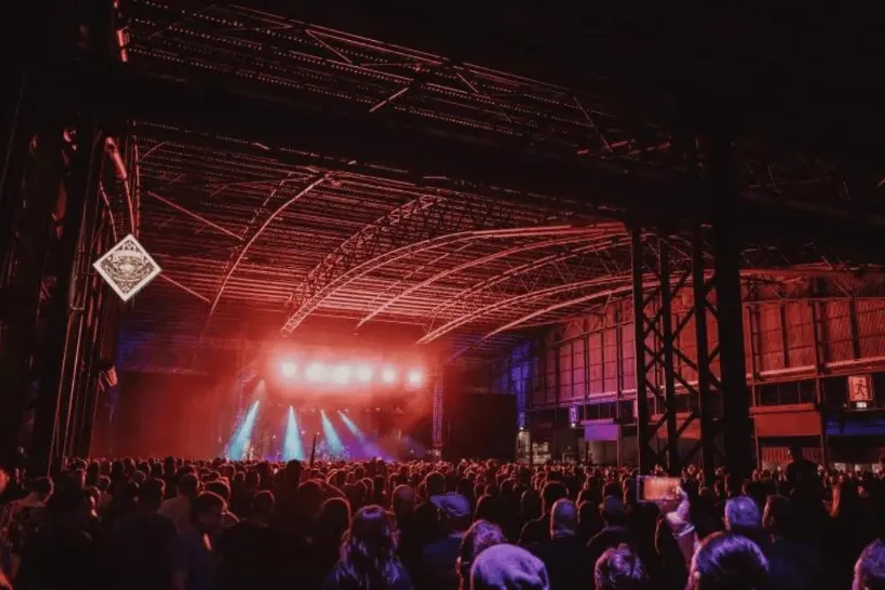 Image inside a music / live performance venue with a stage in the distance